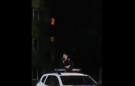 VIDEO Un bărbat a fost filmat pe tavanul unei mașini de poliție. Autoritățile au pornit o cercetare penală