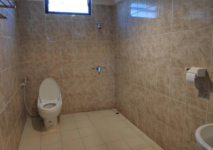 O baie din hotel facuta pentru oameni care au nevoie de maini foarte lungi pentru a ajunge la hartia igienica